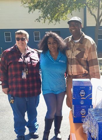 A man smiles in a picture with two women.