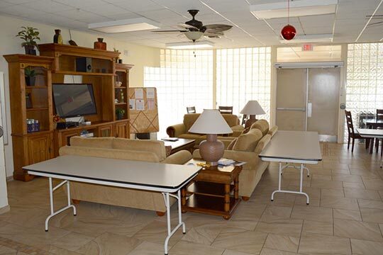 The Tranquil Terrace living room featuring a couch a tables. 