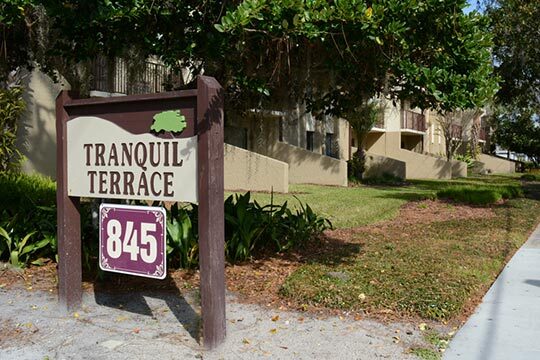 The Tranquil Terrace Apartments sign.
