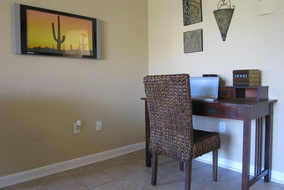 A small table and chair are placed up against a wall in this one-bedroom rental.