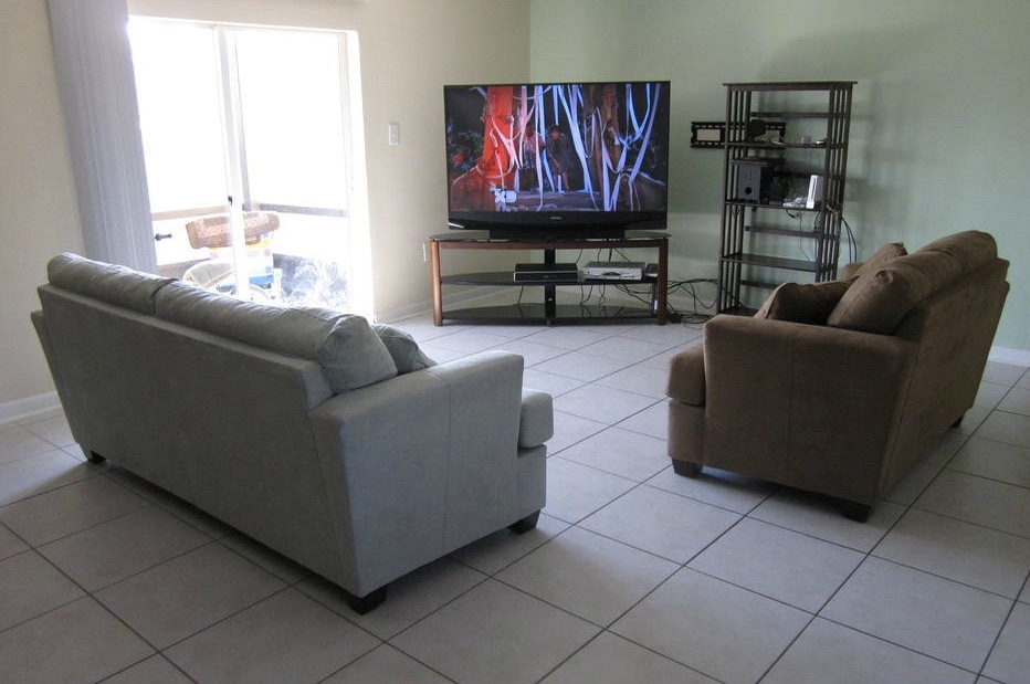Two couches face a television in the living room of the three-bedroom rental.