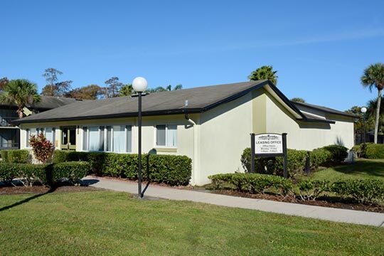 The front of the Leasing Office has neatly trimmed hedges and landscaping. 