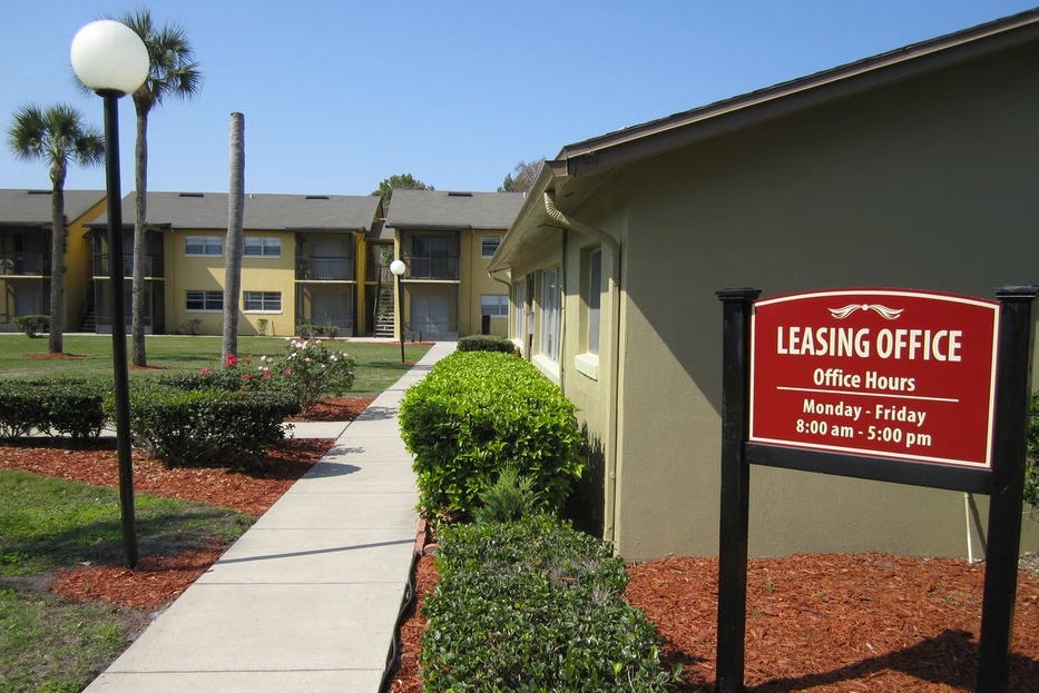 The walkway and sign outside of the Leasing Office.