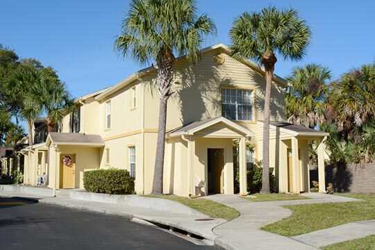 Palm trees are planted on either side of the door to this rental. 