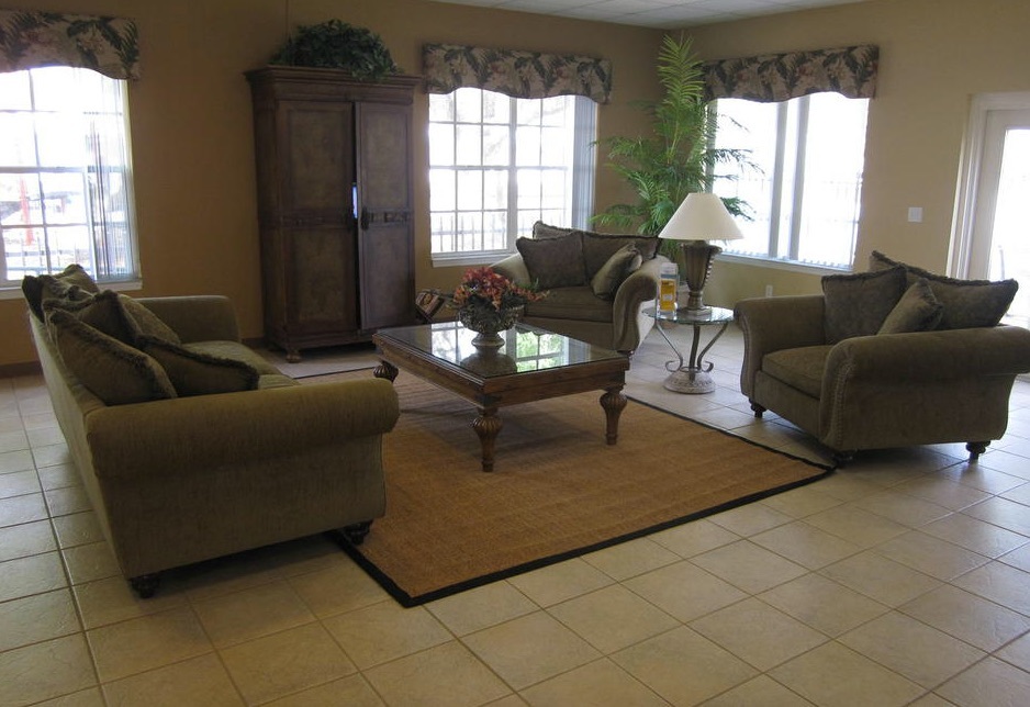 A shared community space with one couch facing two chairs. 