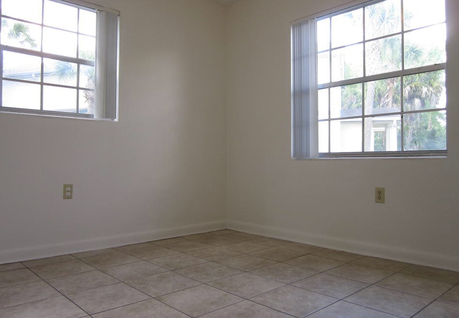 There is a window on both walls in a bedroom in the three-bedroom rental.