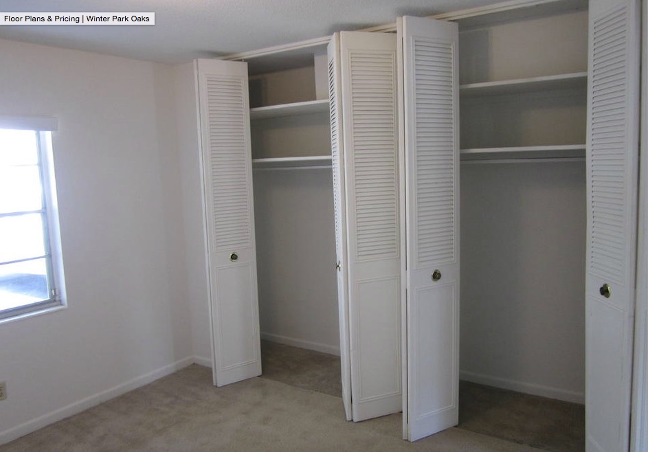 Two closets with doors wide open are side by side in an empty bedroom of the two-bedroom rental. 