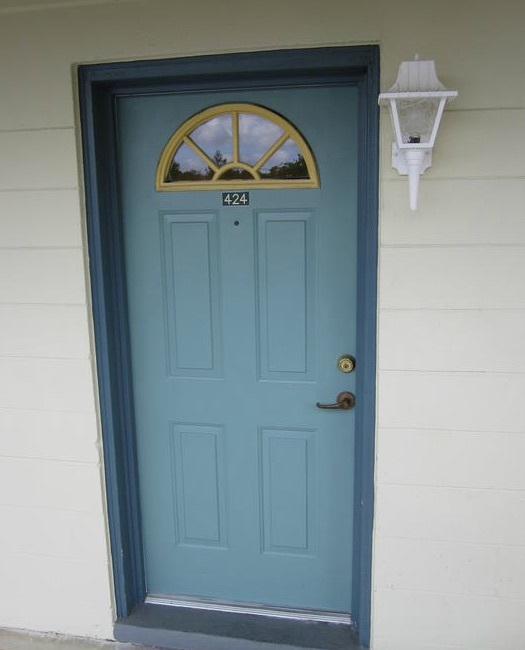 The door to rental number 424 has a half-moon-shaped window at the top. 