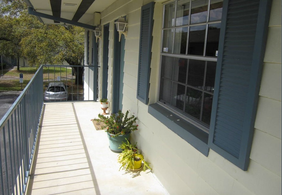 Colorful shutters line the outside of the windows and the handrails and guttering are painted to match the shutters. 