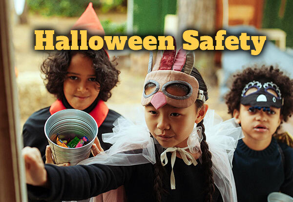 Children in Halloween costumes ringing a door bell
