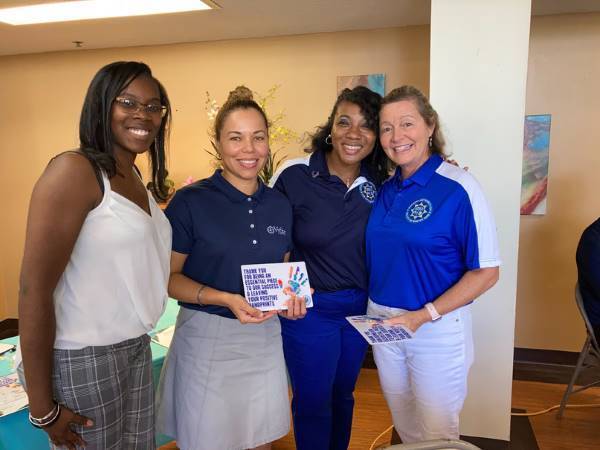 Executive Director LaShanda Lovette presenting Community Partner recognition pin