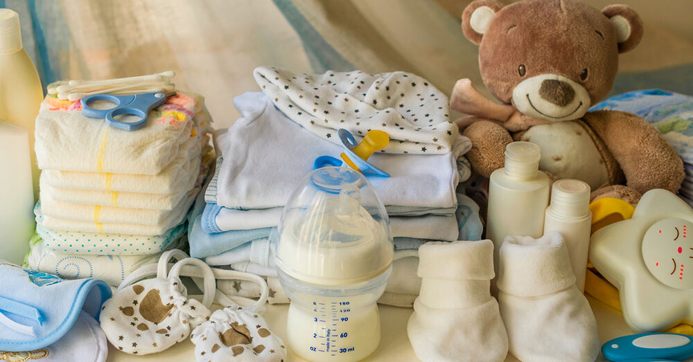 Baby supplies laying on a blanket in an orderly fashion.