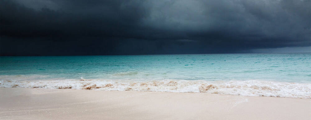 A dark and stormy beach line.