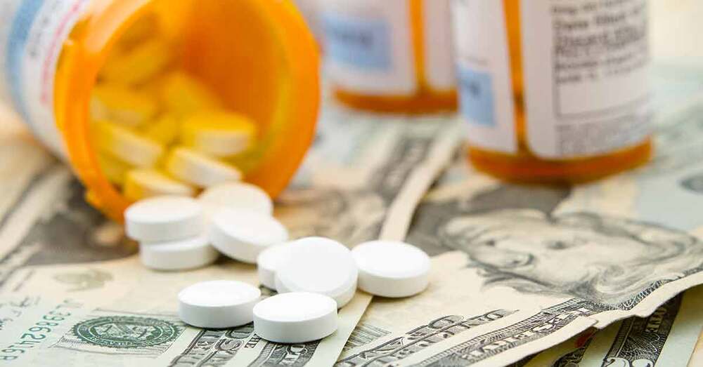 Bottles of prescription medicine laying on U.S 20 Dollar Bills.