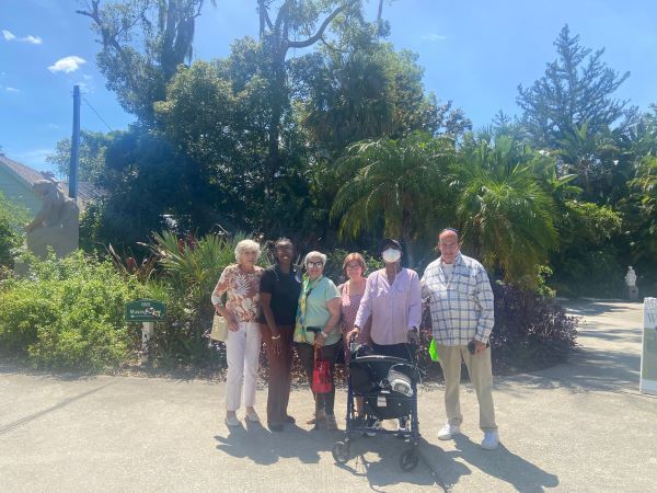 Group of people posing for a photo smiling.