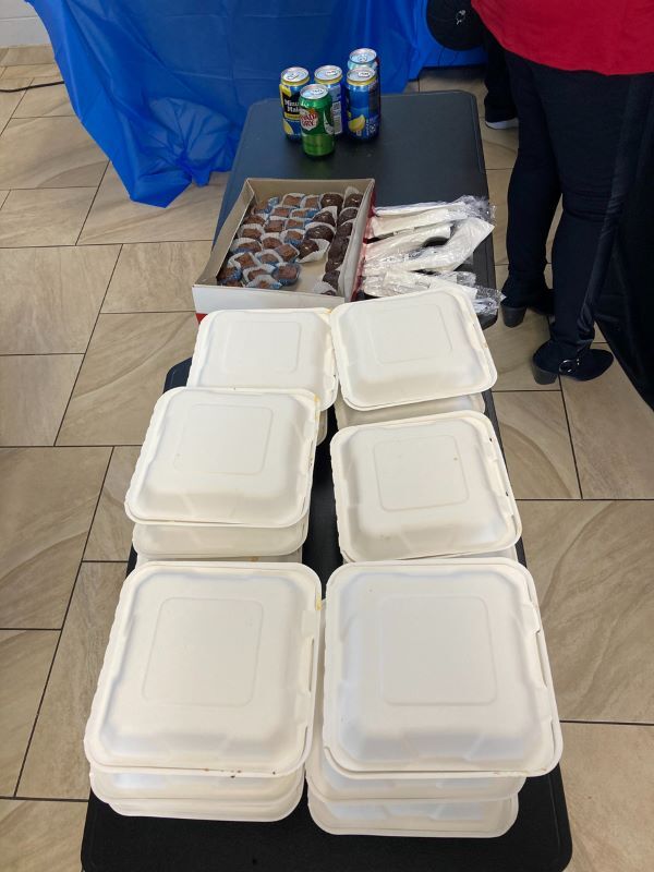 Styrofoam boxed lunches on a table ready for distribution. 