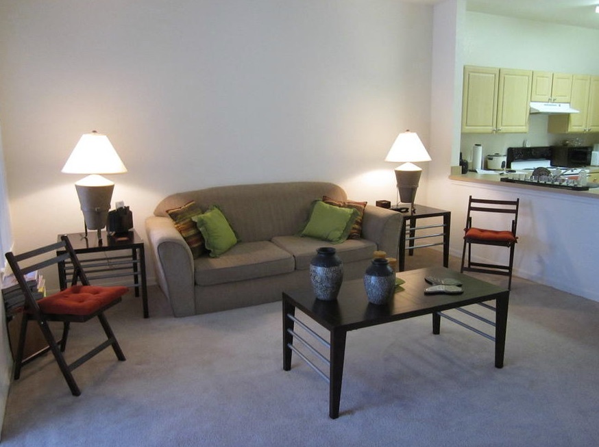 A living room with a couch and table at Railroad Avenue.