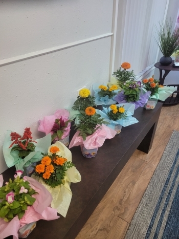 Table against the wall covered in flowers.