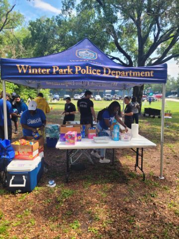 Winter Park Police Department Tent setting up chips and food.