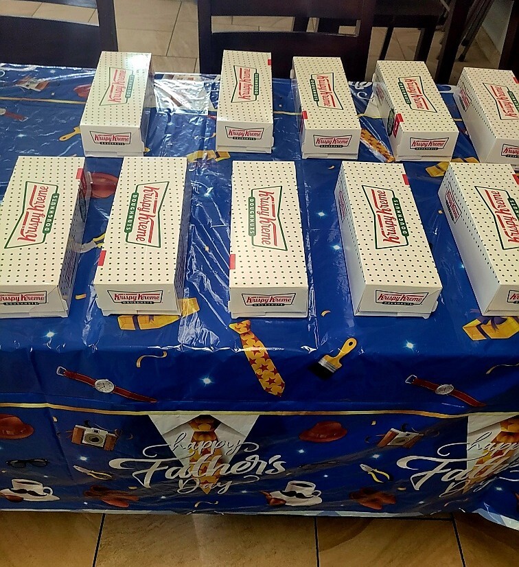 A table full of Krispy Kreme boxes.