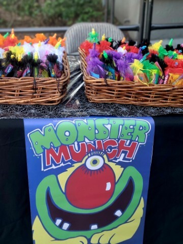 Table with candy and a sign with the text Monster Munch. 