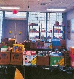 Room full of groceries and supplies on tables.