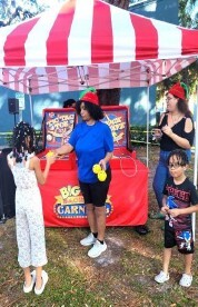 A woman talking to children about a game.
