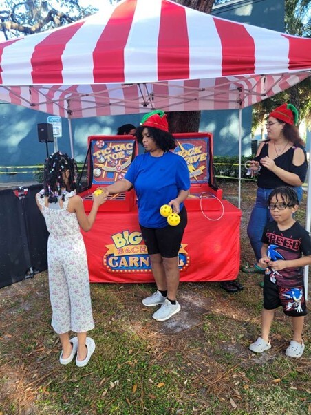 A woman playing games with kids outside.
